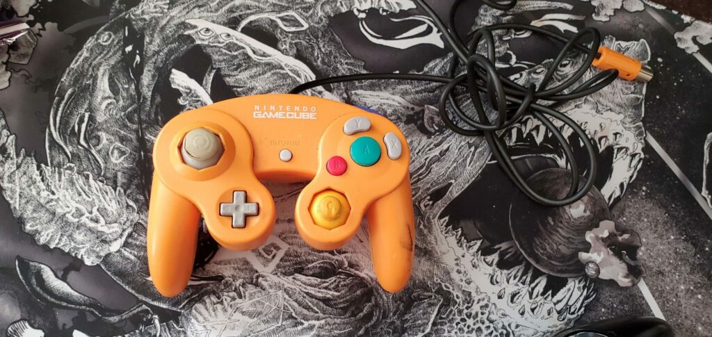 Image via Dabuz | His old orange controller with a much-too-short wire