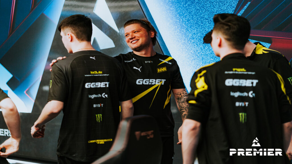 Photo of three Natus Vincere Counter-Strike players. The one in the middle was caught smiling. Since he was moved to NAVI's bench, s1mple has only played for Falcons in CS2.