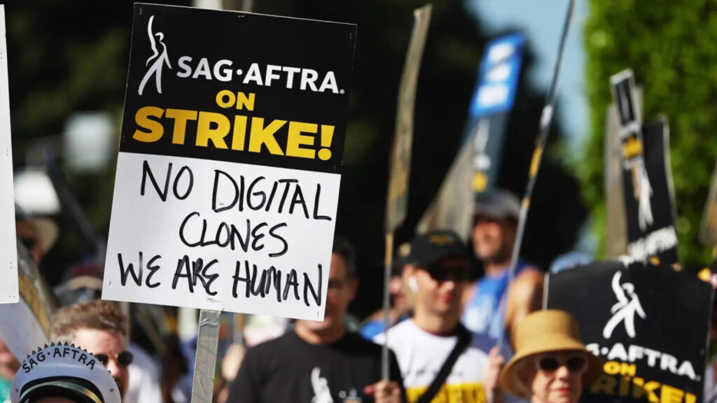 "No digital clones, we are human" can be read in the poster (Image via Mario Tama/Getty Images)