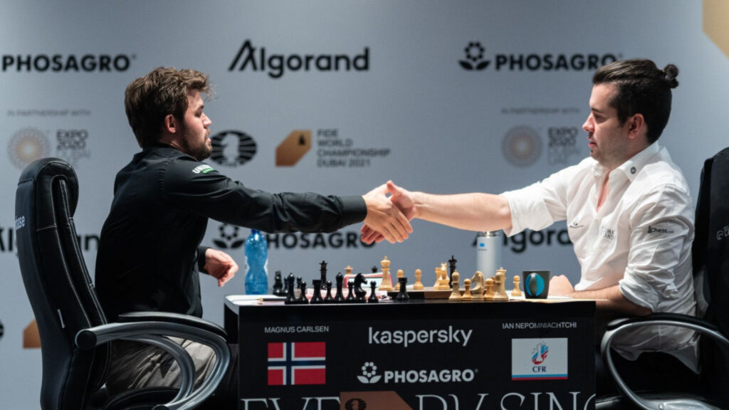 Photo of Carlsen accepting Nepomniachtchi's resignation of Game 6 of the 2021 World Championship (Image via Maria Emelianova | Chess.com)