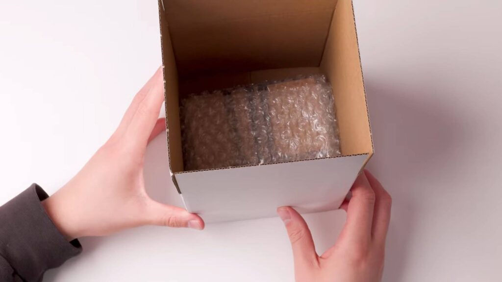 Here's what your shipping box to PSA should look like. Don't forget to add more bubble wrap and your submission form. (Image via <a href="https://www.youtube.com/@PSAcard_Official">PSAcard YouTube Channel</a>)