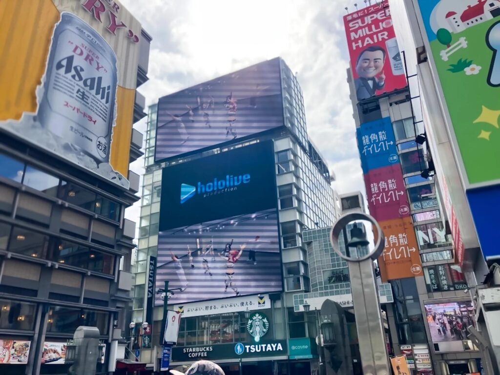 hololive production's "Feelings Transcend Dimensions" playing in a digital billboard (Photo via hololive production)